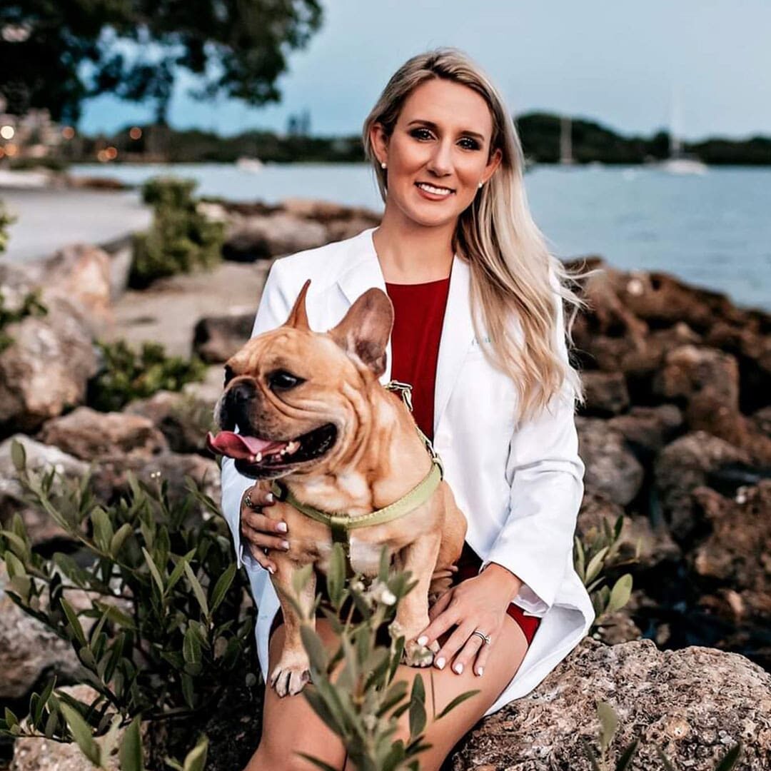 Dr Jenny Dakin posing for a picture outdoors with a dog